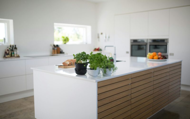 pexels-photo-1358900-1358900 Spacious, light-filled kitchen with modern design and fresh herbs on the counter.